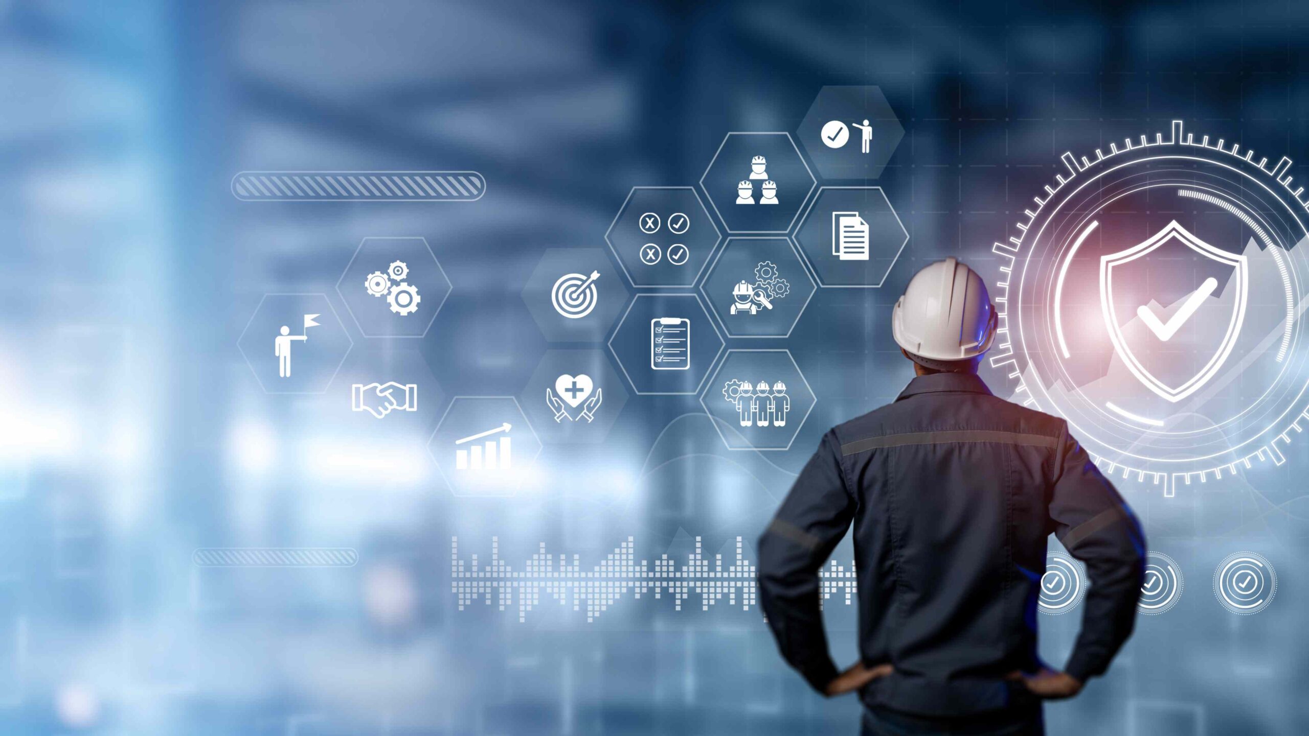 Engineer wearing a safety helmet viewing a futuristic digital interface with safety and compliance icons, symbolising AI-driven safety management and workplace compliance in 2025.