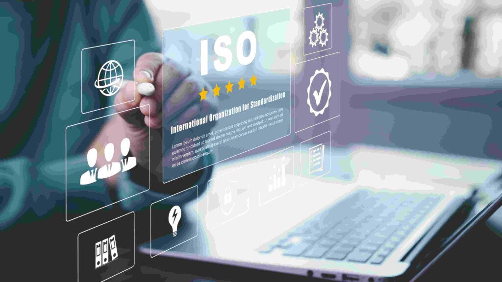 Person using a laptop with holographic ISO certification icons showing quality, compliance, and standardisation.