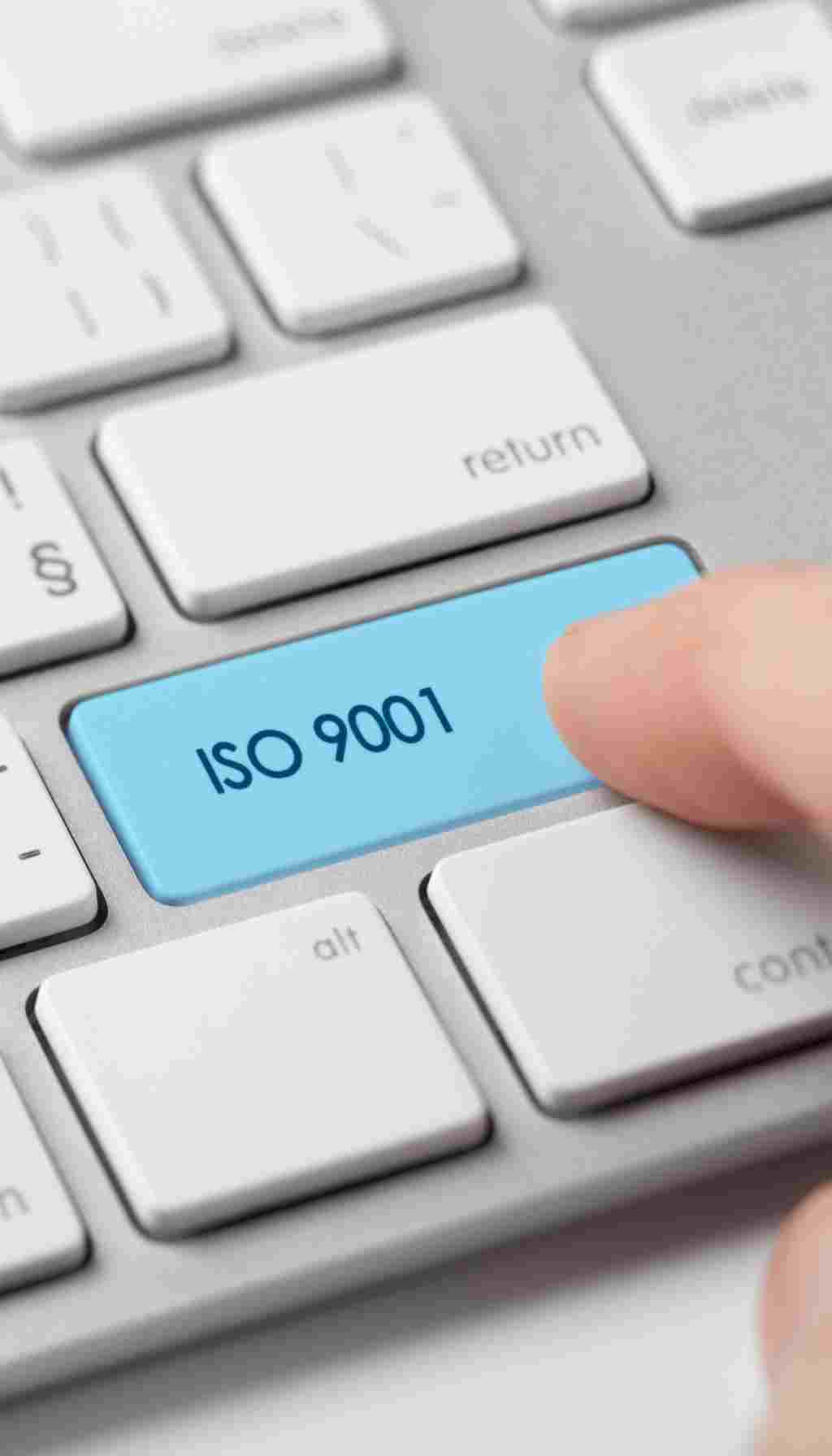 ISO 9001 Quality Management Shortcut Key Concept Finger pressing a blue keyboard key labelled “ISO 9001,” symbolising digital access to quality management systems.