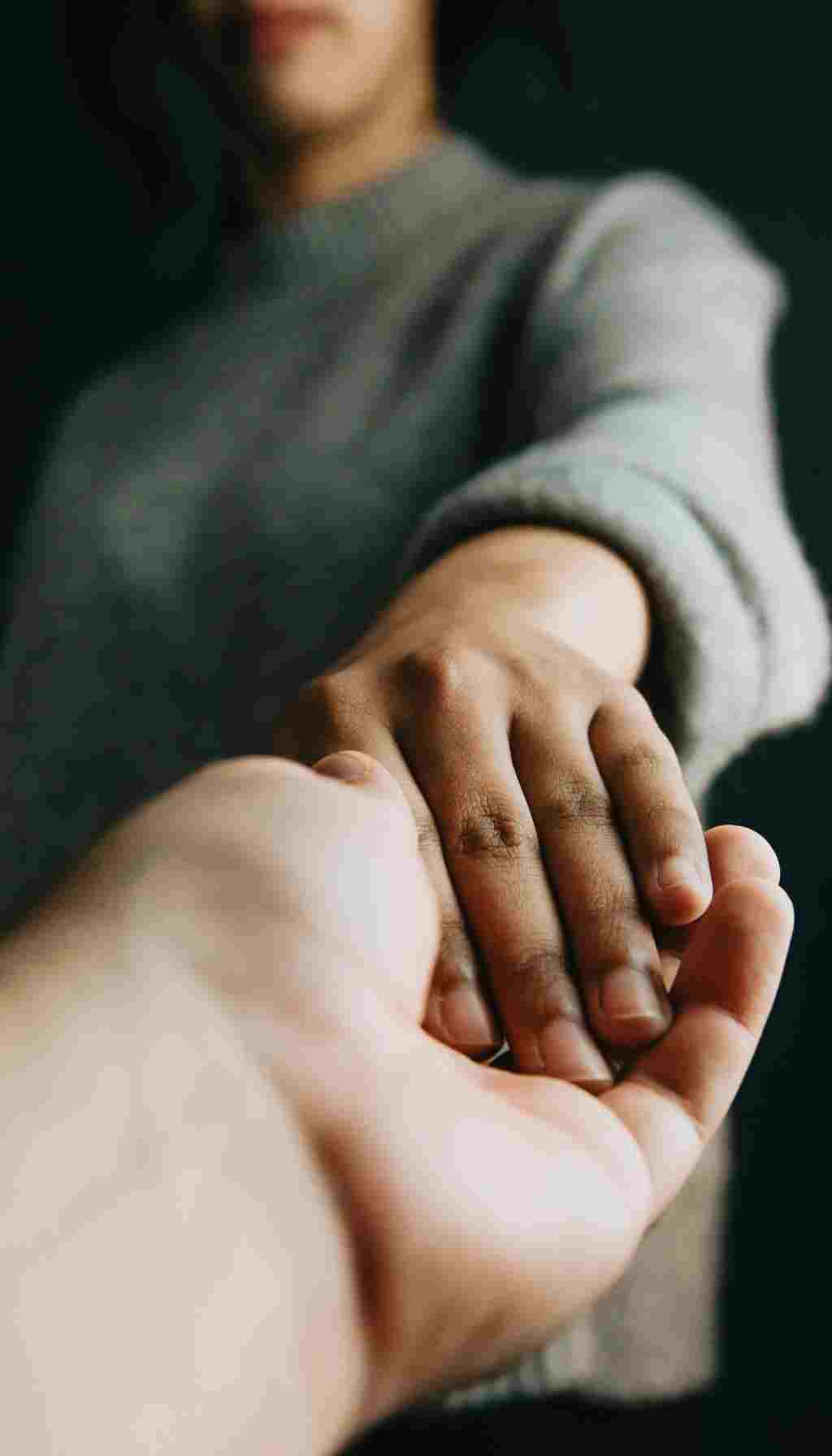 Workplace Wellbeing Support – Compassion and Psychological Safety Close-up of one person offering supportive hand to another, symbolising empathy and wellbeing