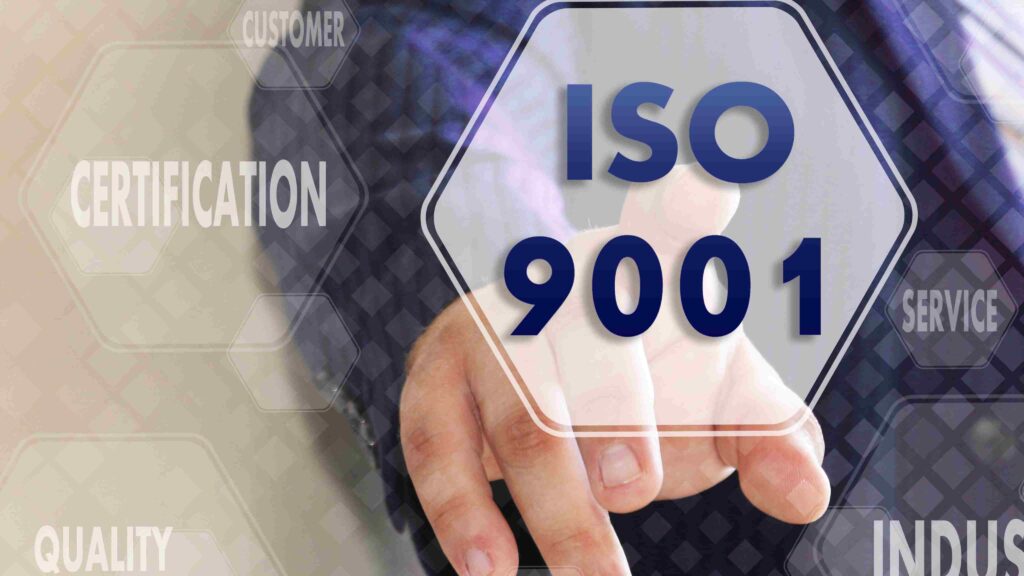 Business professional pointing to an ISO 9001 certification graphic symbolising quality management in integrated ISO systems