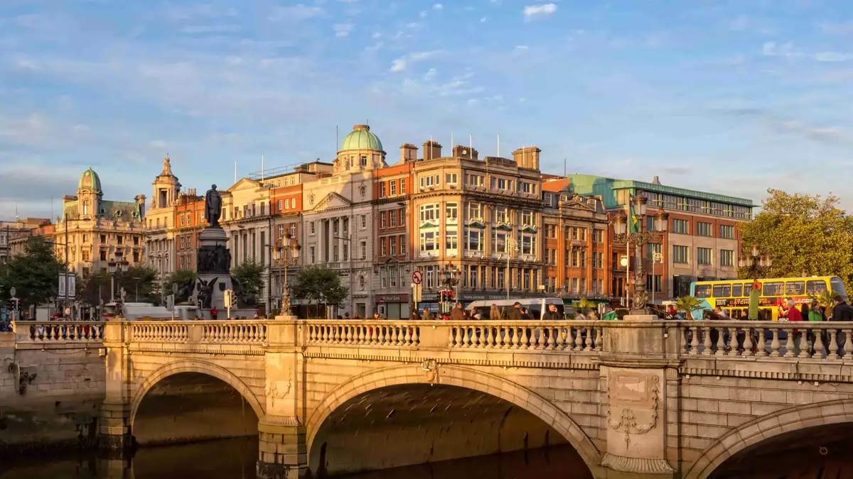 O’Connell Bridge crossing the River Liffey with historic buildings and city traffic in central Dublin.