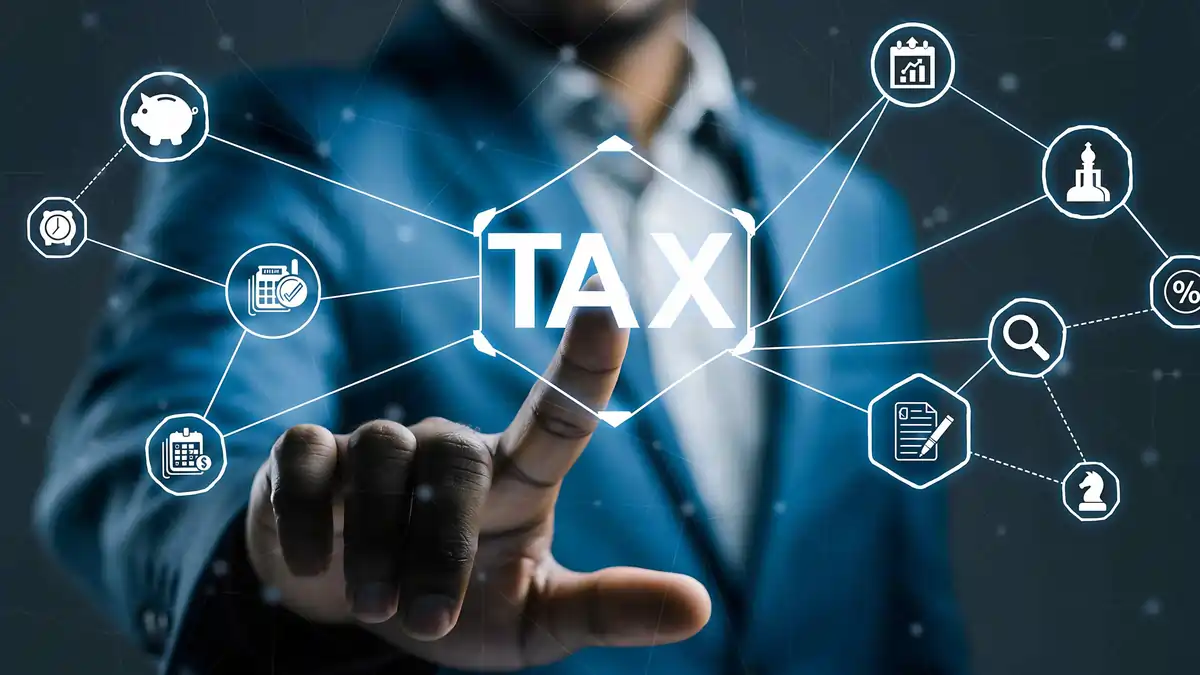 Digital Tax Interface Concept with Business Professional Business professional touching a digital interface with the word “TAX” and connected financial icons representing compliance, calculation, and strategy.