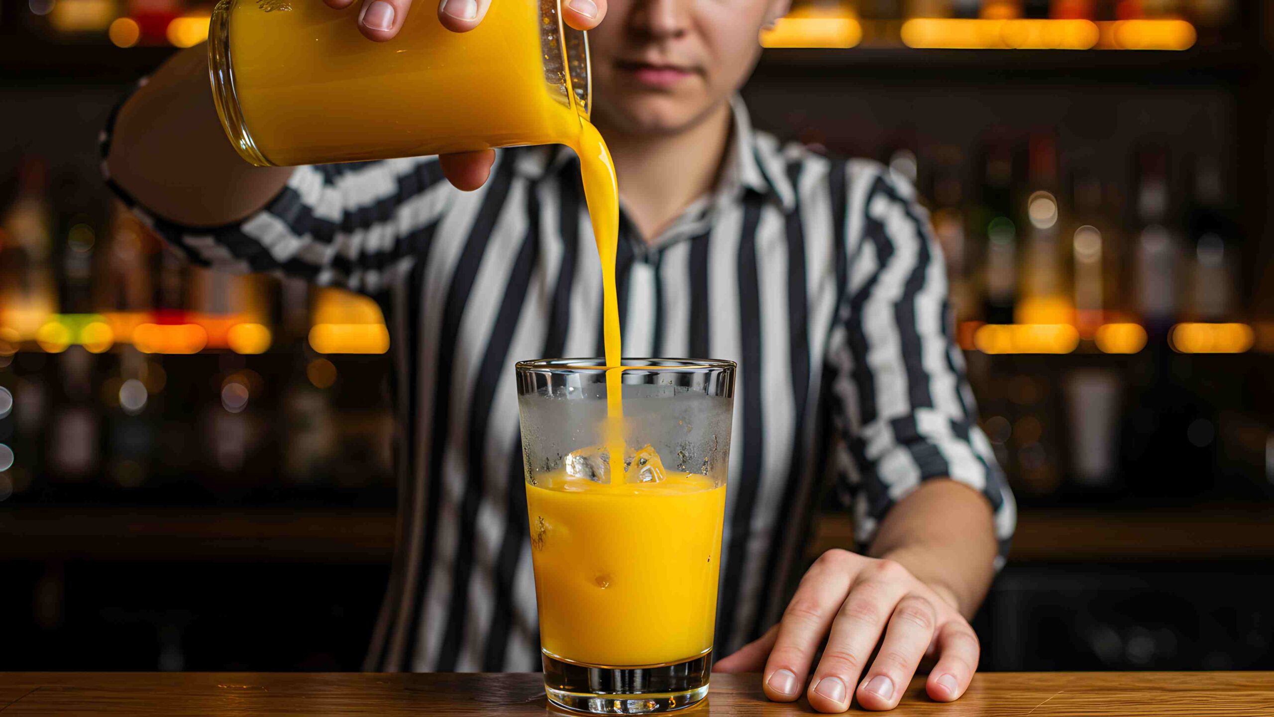 Gloved Worker Filling Plastic Beverage Bottle in Production Line A worker wearing a blue glove holds a plastic bottle being filled on a beverage production line, highlighting hygiene and food safety procedures.