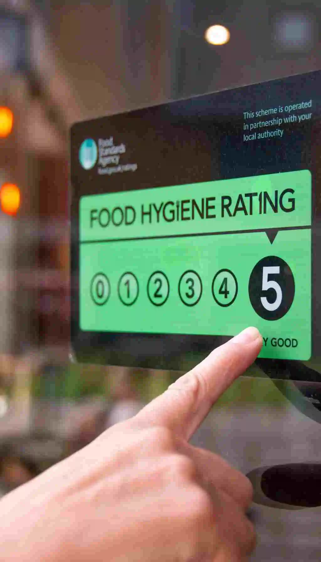 Food hygiene rating certificate showing a top rating of 5 displayed on a restaurant window