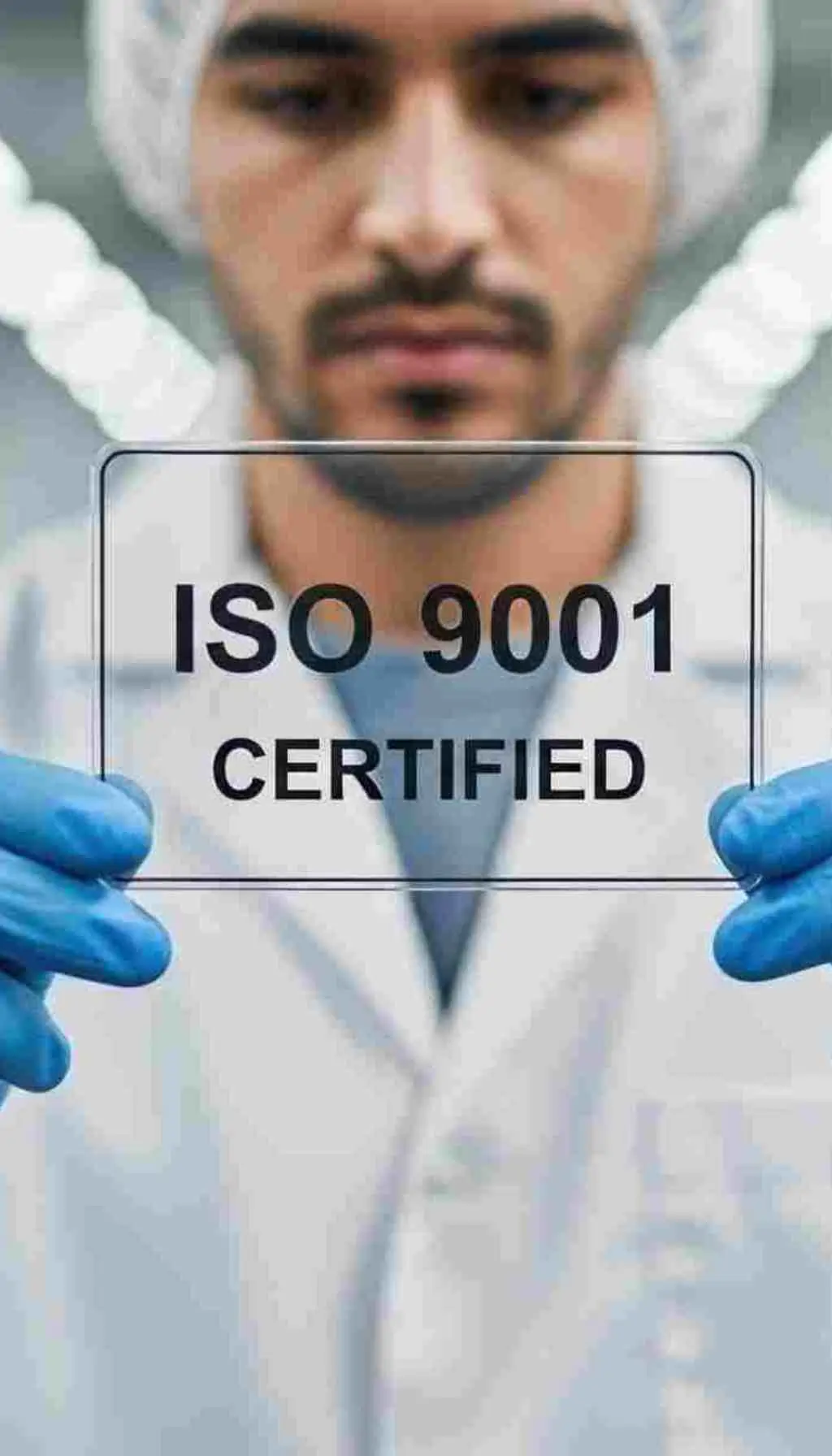 ISO 9001 Certification Enhancing Quality Management for the Future Engineer or technician wearing gloves holding a transparent sign with ISO 9001 certified text, representing quality management standards.