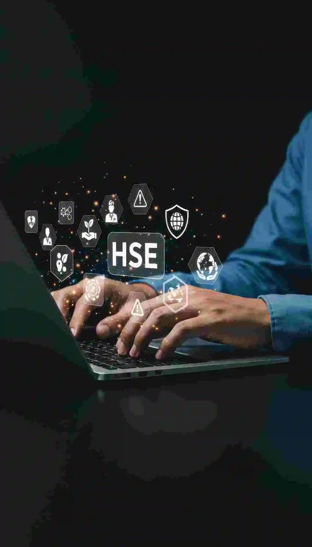Hands typing on laptop with HSE icons representing digital transformation in workplace safety, training, and compliance.