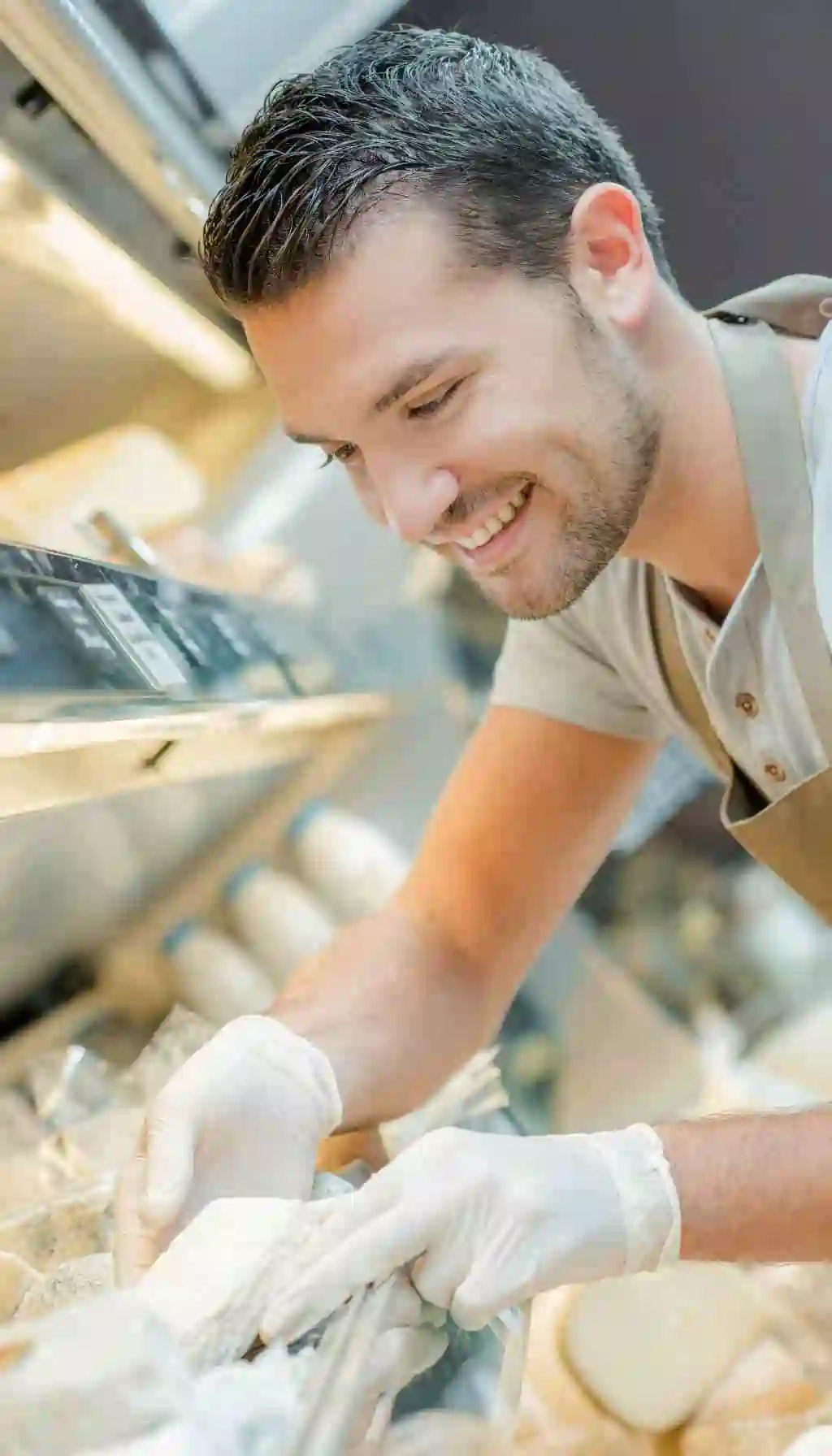 Food Service Worker Handling Packaged Food with Gloves – Hygiene Control Food service worker wearing disposable gloves while handling packaged food, highlighting hygiene and allergen control responsibilities.