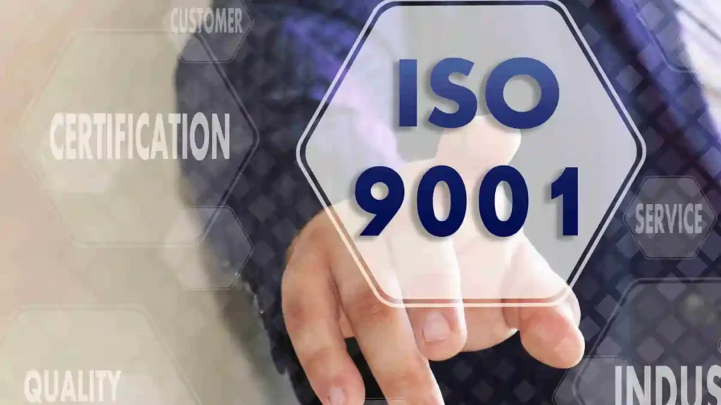 Business professional pointing to an ISO 9001 certification graphic symbolising quality management in integrated ISO systems