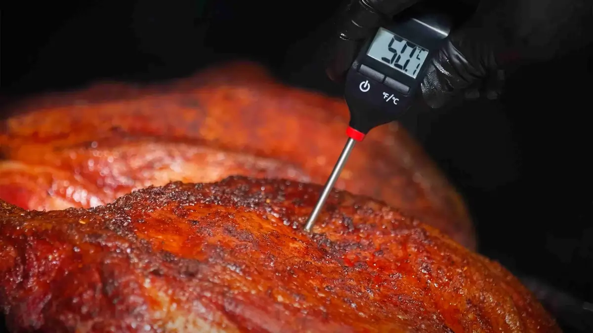 Waiter serving a plated main course at a restaurant table during evening service
